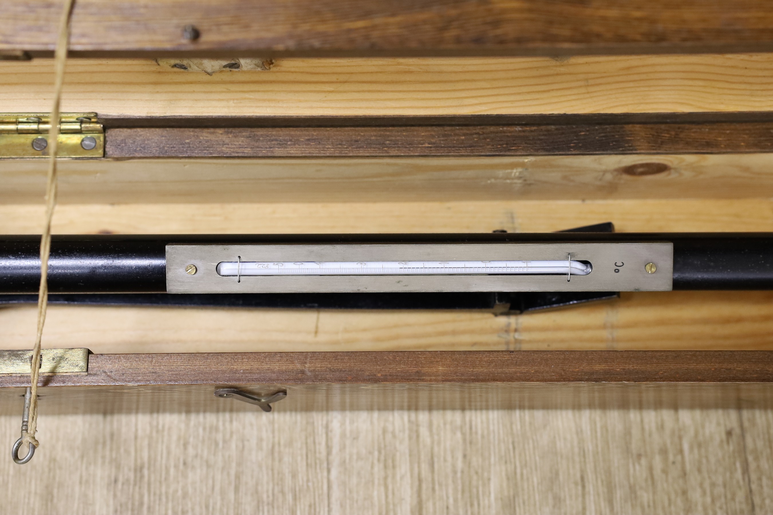 A 20th century marine barometer in a pine case, barometer 39 cms long